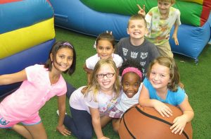 School Day Off Campers playing on large inflatables at Westmont Yard Indoor Sports Complex