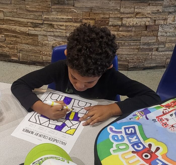 Grade school students doing homework during before and after school care at Westmont Yard in Westmont IL