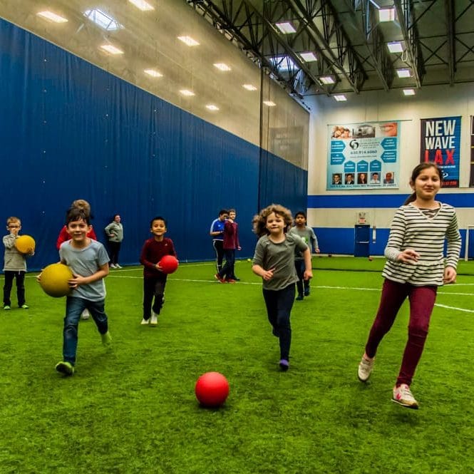 Kids in the After School Sports program playing on the indoor turf field at Westmont Yard in Westmont IL